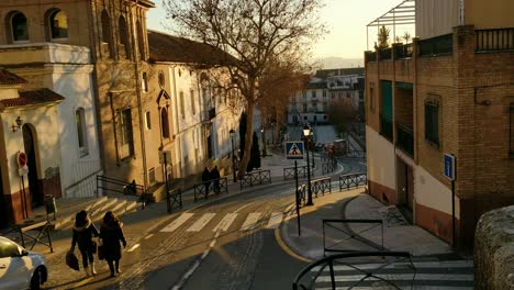 casual street on a hill during sunset spain female walking