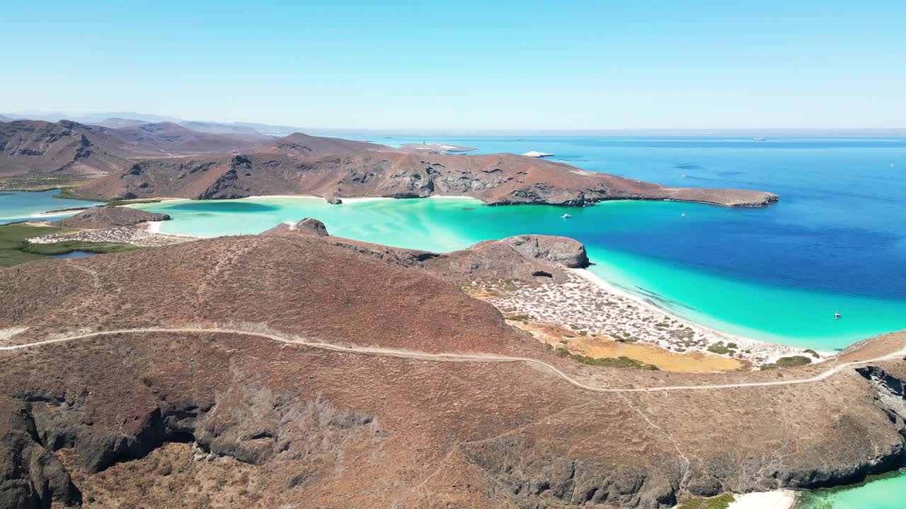 Serene aerial view of Tecolotito beach in La Paz, Mexico, showing clear turquoise waters