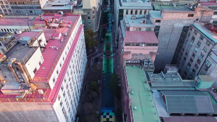 Aerial view flying down Paseo Bandera colourful urban street walkway art in Santiago city centre, Chile
