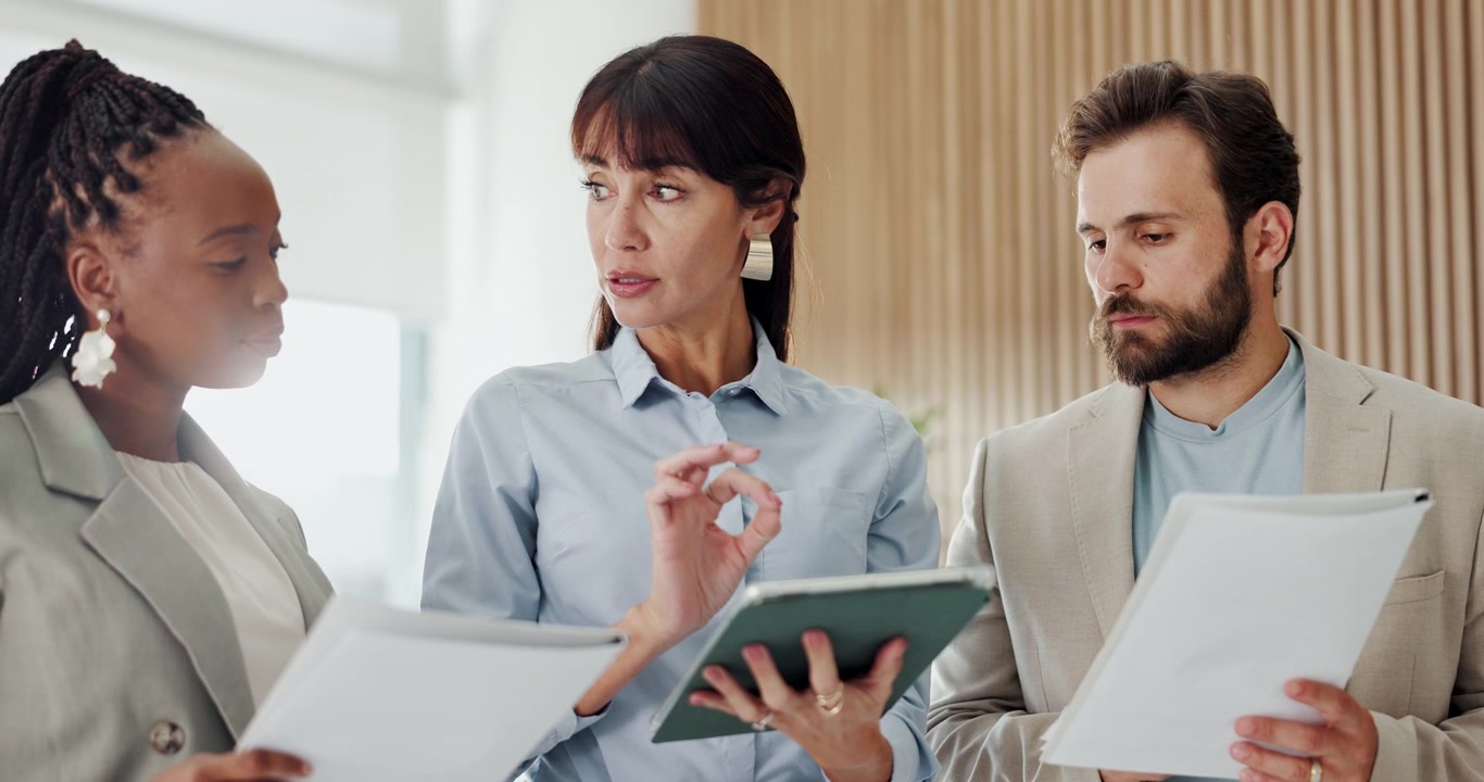 Diverse Business Team Collaborating on Project in Modern Office