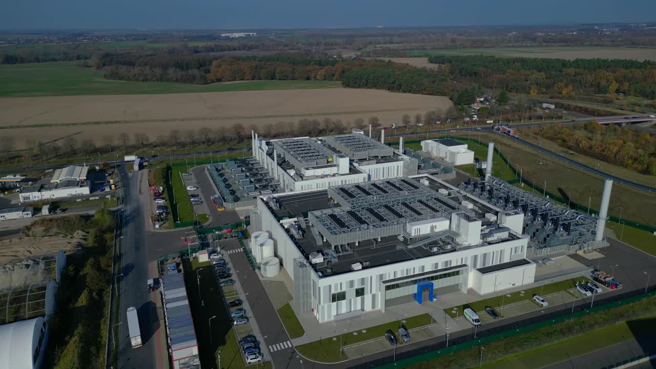 cutting edge technology and futuristic Ai infrastructure of a large-scale data center campus in Germany processing global information. Fantastic aerial view flight static tripod hovering drone