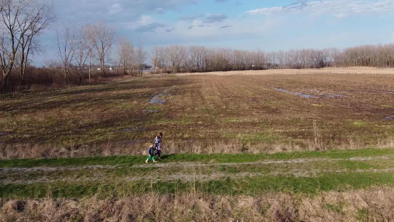 Kids Walking Through Flat Lands At Monroe Michigan - Wide shot