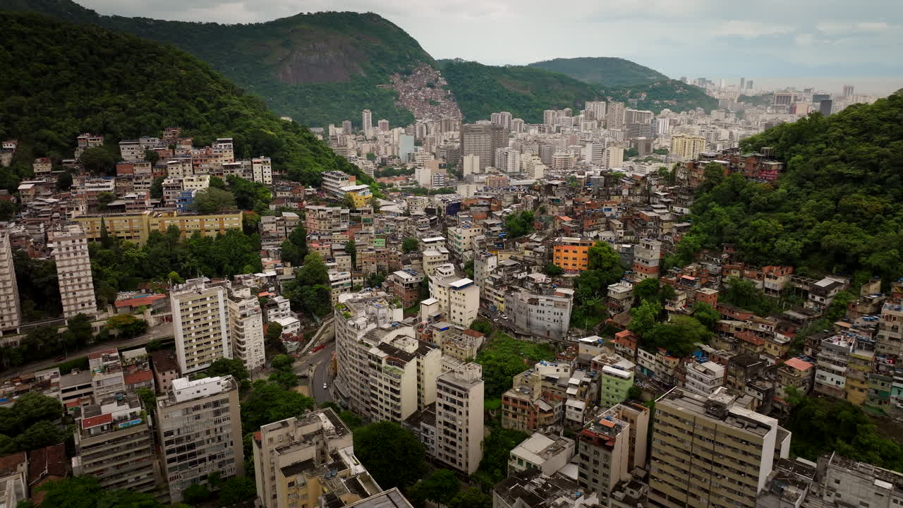 Favela Copacabana on hillside contrasts against city buildings in Rio de Janeiro