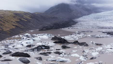 glacial lagoon filled with icebergs at kvíarjökull glacier, melting by global warming