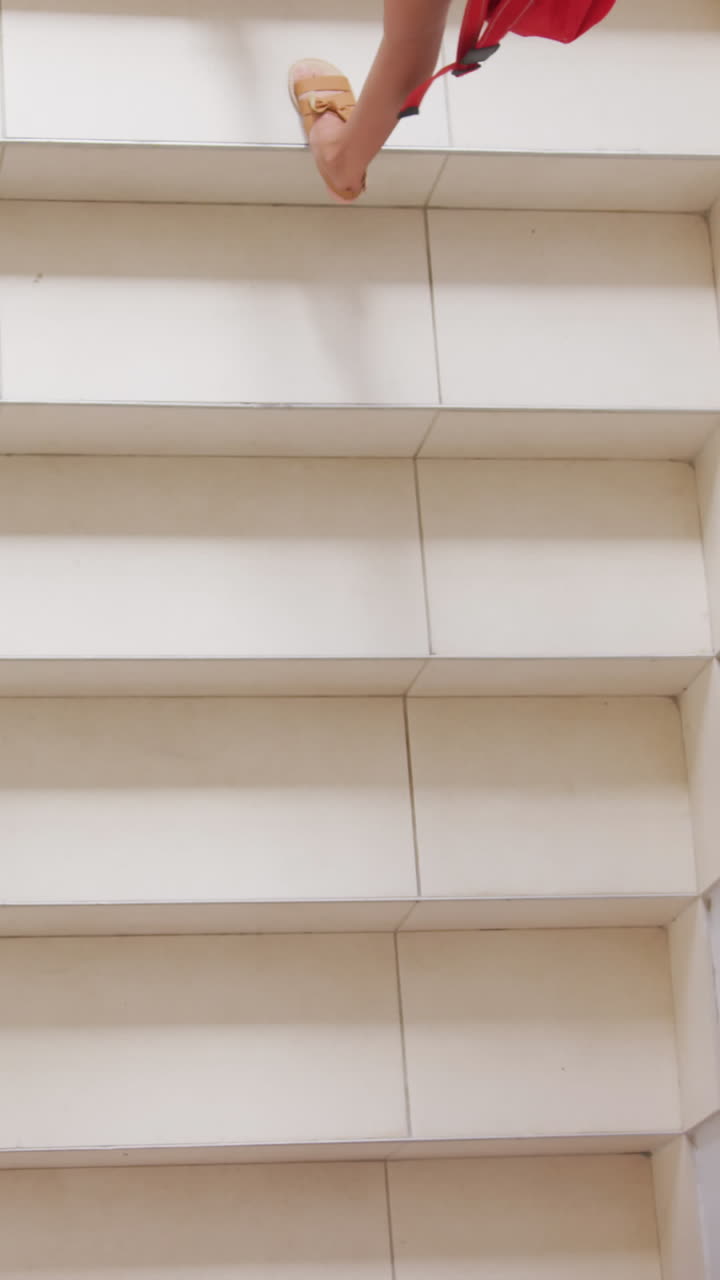 Video of top view of diverse girls walking upstairs at school
