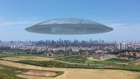 ufo hovers over a city and rural landscape