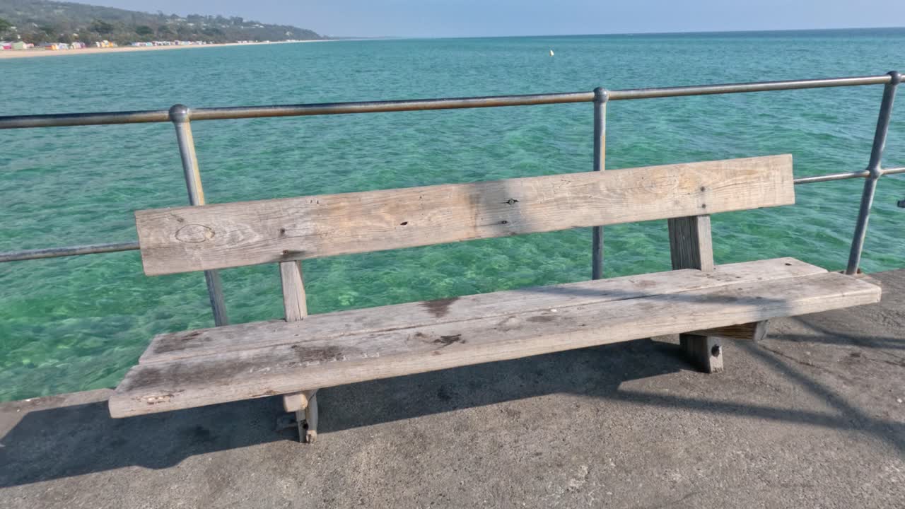 A bench on a pier overlooking the sea