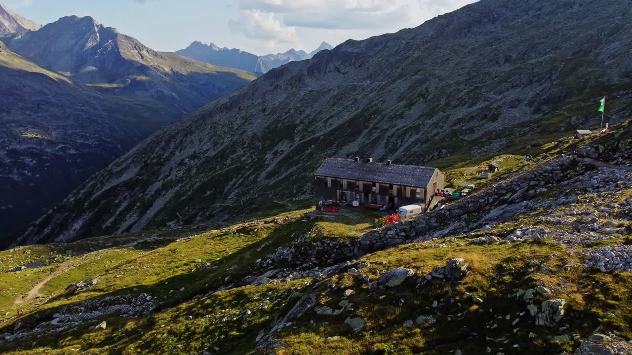 drone shot beautiful scenic view of European hut named "Olpererh&uuml;tte" in Austrian Alps in summer with the Schlegeis Stausee below