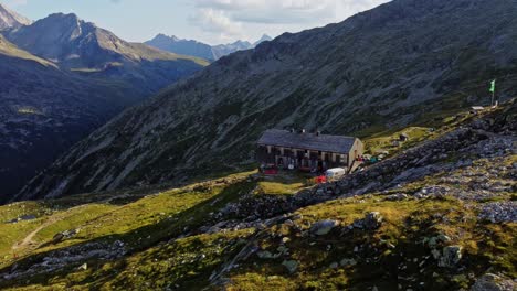 drone shot beautiful scenic view of european hut named "olpererhütte" in austrian alps in summer with the schlegeis stausee below