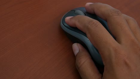 male hand on the wireless mouse of computer
