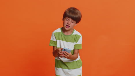 young boy experiences discomfort and frustration while using smartphone