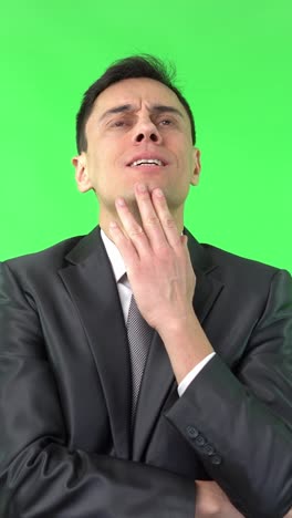 man showing pain or discomfort on a green screen
