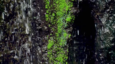 waterfall between stones with moss