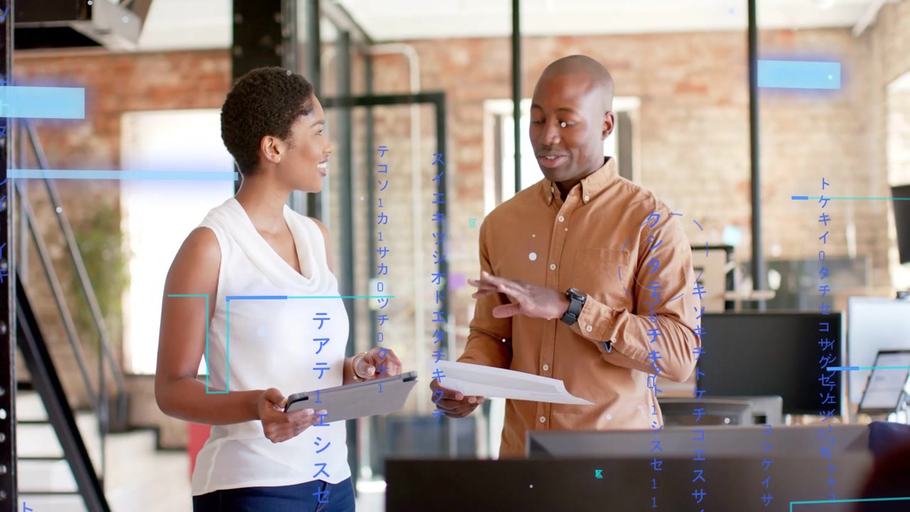 Man presenting papers in biz hub, woman tapping tablet, blue graphics marking data both agreeing