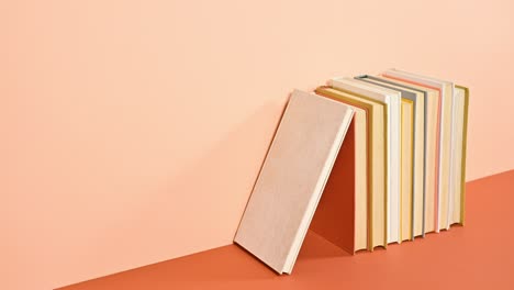 red desk lamp come out from improvised house made of books on deep and bright orange theme. stop motion