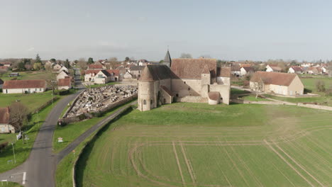 aerial drone footage of the eglise du prieure saint-michel or saint michel priory church in the village of le magny, france