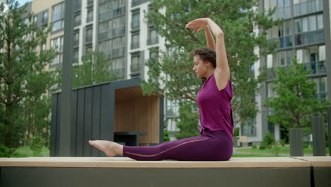 woman doing yoga outdoors in urban setting
