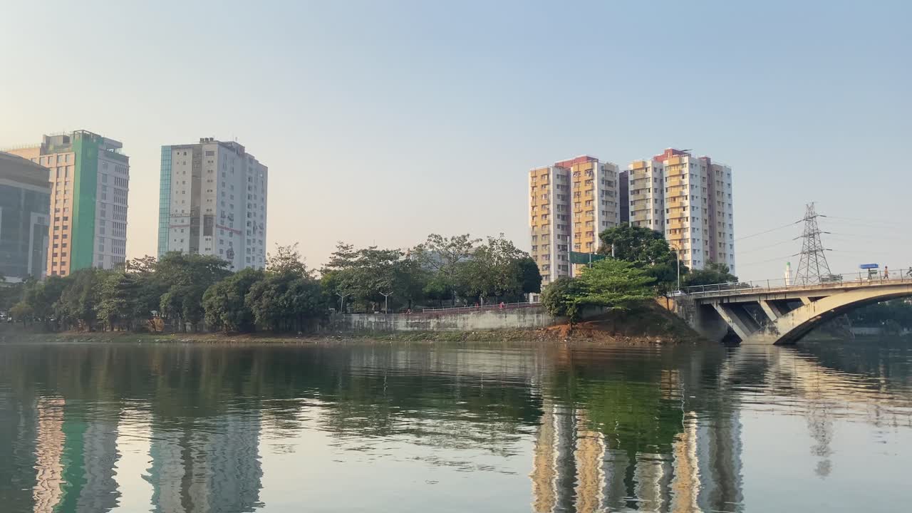 Wide Shot Pan Left of Road Bridge over a lake at a city