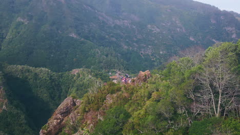 hikers exploring scenic cliffs of verdant landscape aerial view. green mountains