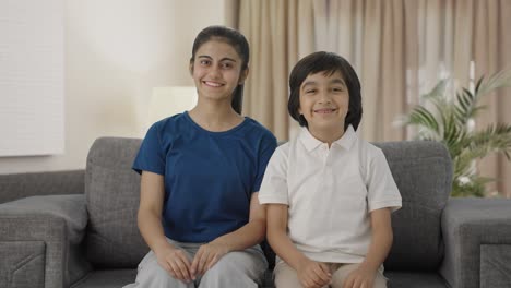 Happy-Indian-sibling-smiling-to-the-camera