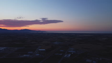 aerial view of sunset over countryside and coastal area