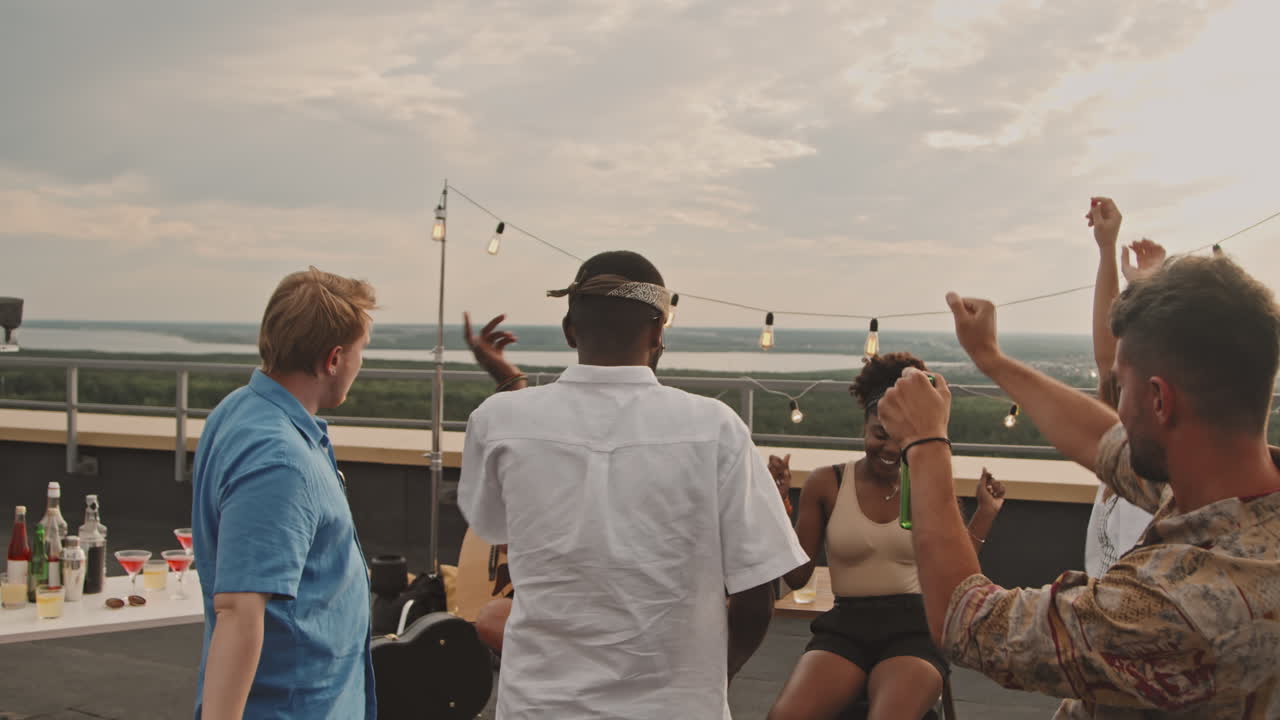 Group of Young Friends Partying on Rooftop
