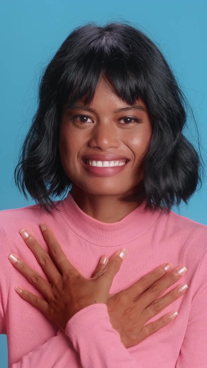 Surprised southeast asian woman gasping and holding hands on chest over blue