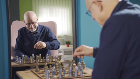 the old man is playing chess alone in front of the mirror.