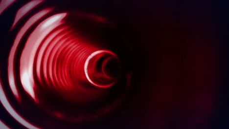 animation of glowing red circles spinning in tunnel