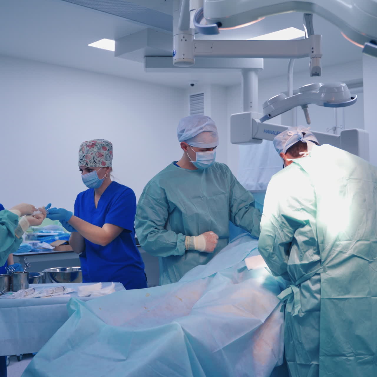 Teamwork of specialists in modern clinic. Stem cells injection procedure. Doctors in the operating room. Health care concept.