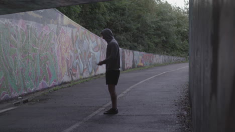 wide shot of athletic man jumping rope in an underpass - ungraded