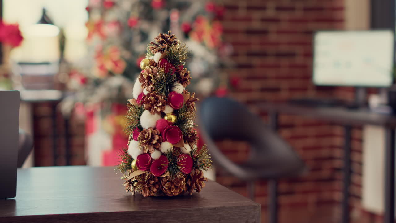 Christmas tree and festive ornaments on office desk