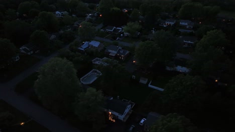 night scene in upper class housing area of american town. aerial top down circling shot. lighting lantern and houses. swimming pool in garden. east state of united states on spring.