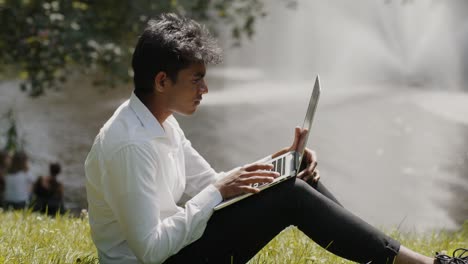 young asian man, student, working in park with laptop, hybrid working, businessman