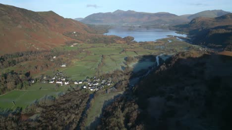 early morning autumn sunlight falling on wide valley with lake