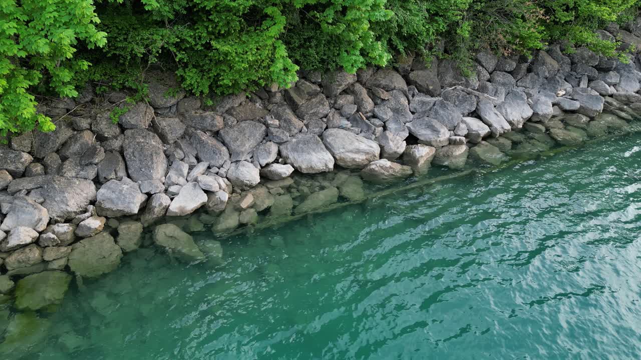 las olas tranquilas alcanzan la costa rocosa del lago walensee creando un fondo meditativo