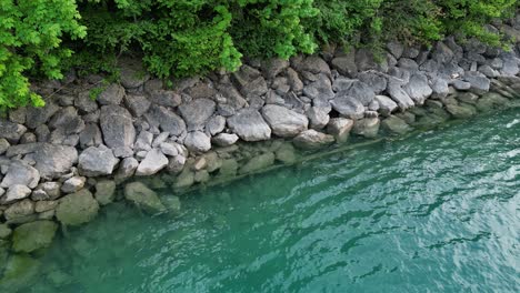 calm waves reaching rocky shoreline of walensee lake creating meditative background