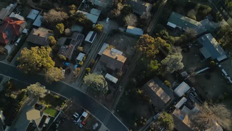 directly overhead drone view of rivett’s rooftops with birds soaring below in late light
