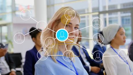 animation of network of profile icons over caucasian businesswoman smiling at a business conference