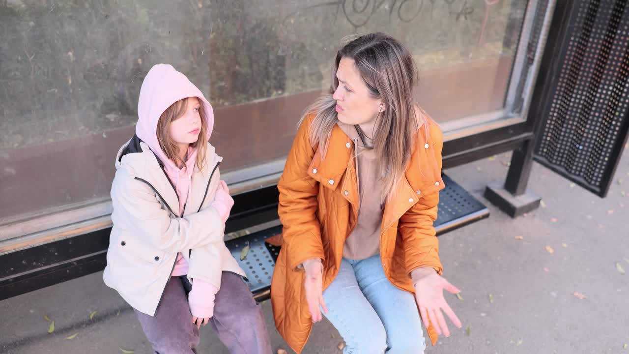 Mother and Daughter at the Bus Stop