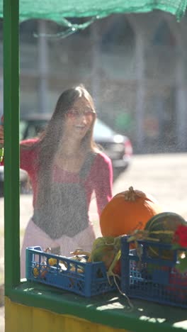 young woman selling produce at a farmer's market