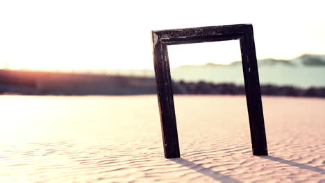 empty wooden picture frame on the beach sand