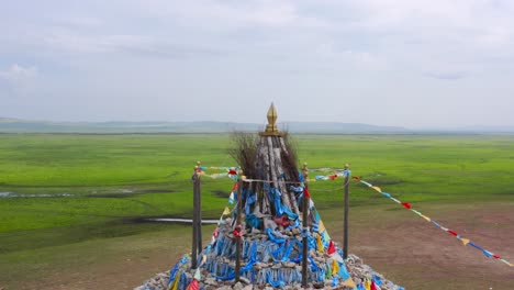 orbit around religious cultural altar in mongolian grasslands plain, drone aerial