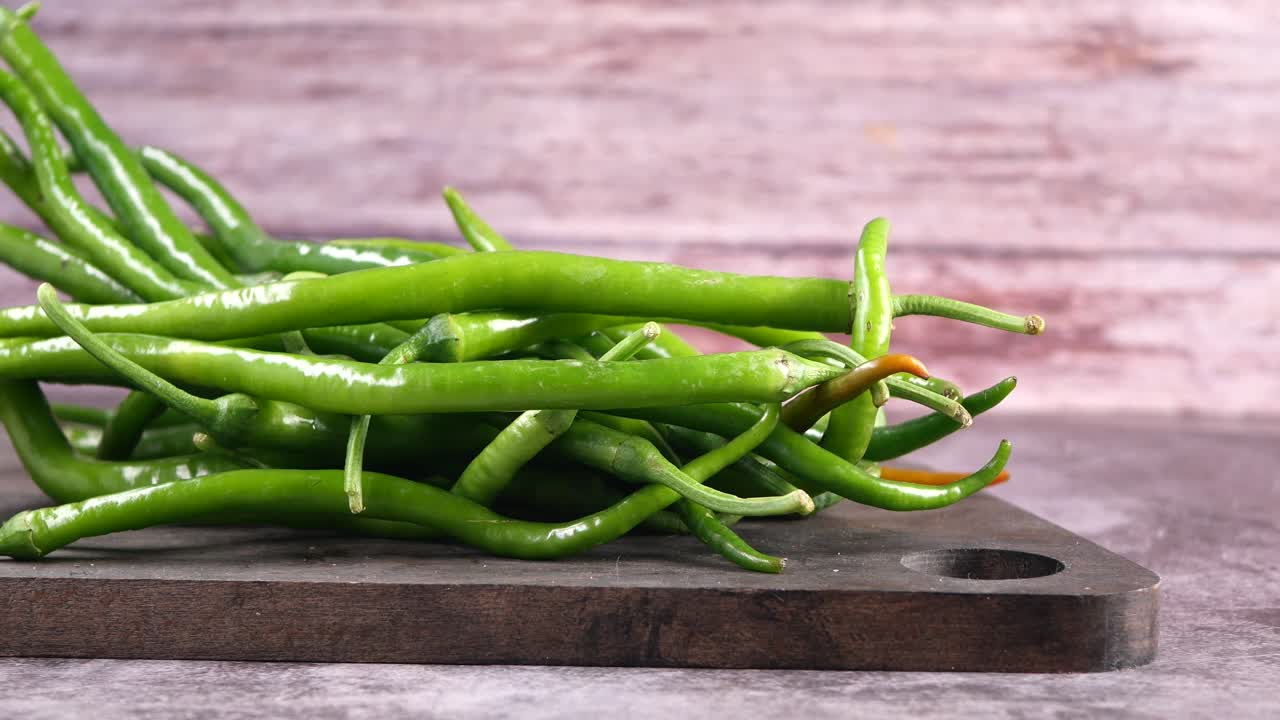 Fresh Green Chili Peppers on a Rustic Cutting Board