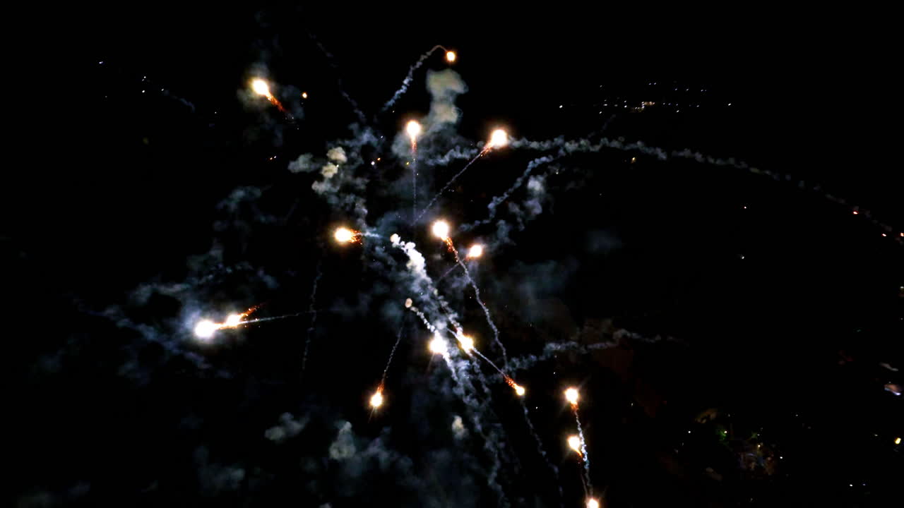 Inside fireworks show with slow motion sparks in the night sky