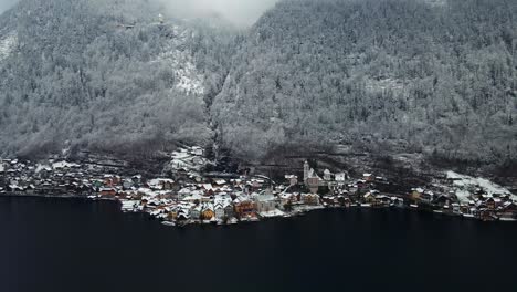 footage filmed with a drone over a lake by a town called hallstatt in austria in europe