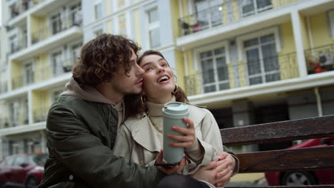 Affectionate-couple-talking-together-outdoor.-Man-hugging-woman-on-city-street.