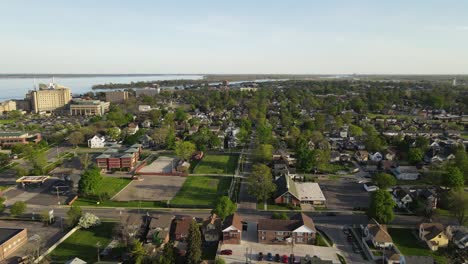 Wyandotte-township-with-driving-cars-in-street,-aerial-side-fly-view