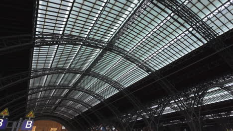 a train leaves a beautiful train station in leipzig, germany, europe during the day