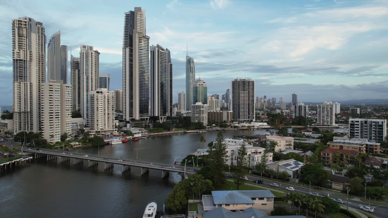Surfers Paradise Skyline With Towering Skyscrapers Along The Nerang River With Busy Bridge. Gold Coast, QLD, Australia. sideways drone shot